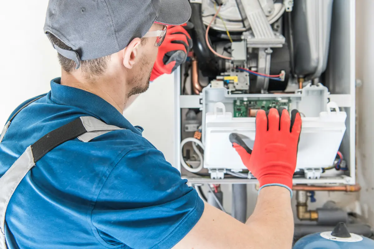 HVAC technician performing annual maintenance on a boiler in Orlando