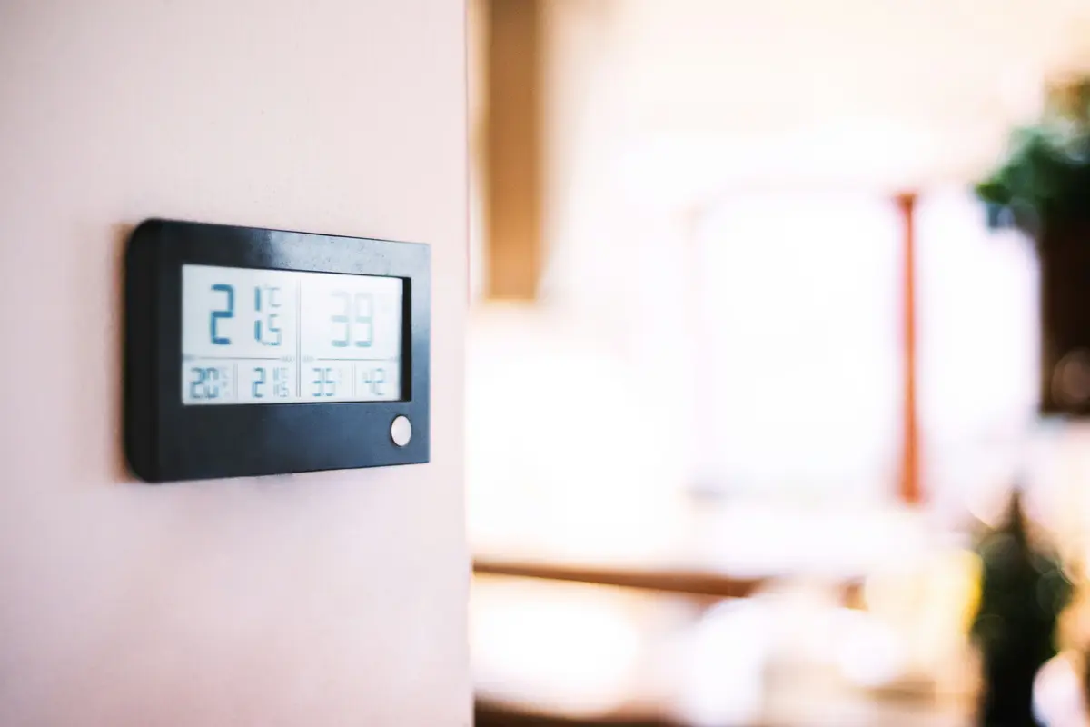 Modern smart thermostat installed on residential wall